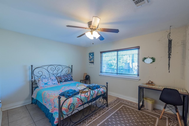 tiled bedroom featuring ceiling fan