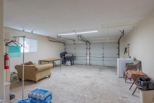 garage featuring washer / clothes dryer and a garage door opener