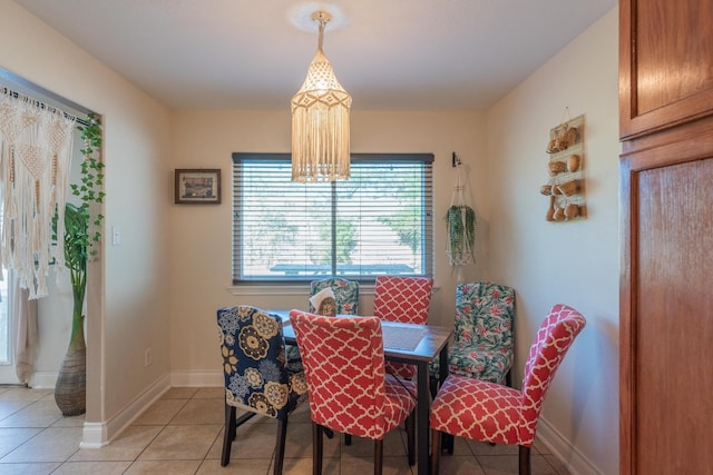 dining room featuring light tile patterned floors and an inviting chandelier