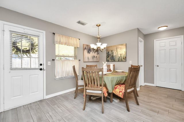 dining room featuring an inviting chandelier and light hardwood / wood-style flooring