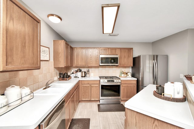 kitchen featuring appliances with stainless steel finishes, backsplash, and sink