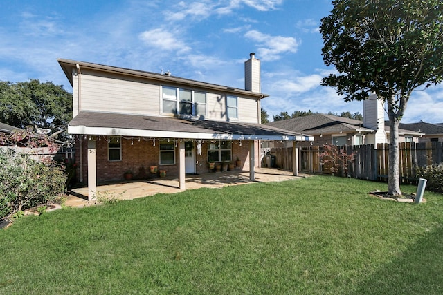 rear view of property featuring a patio area and a yard