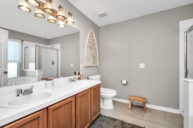 bathroom with wood-type flooring, vanity, toilet, and a shower with shower door