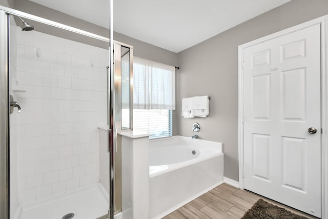 bathroom featuring hardwood / wood-style floors and independent shower and bath