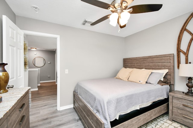 bedroom with light hardwood / wood-style flooring and ceiling fan