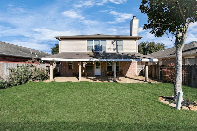 back of property featuring a lawn and a patio