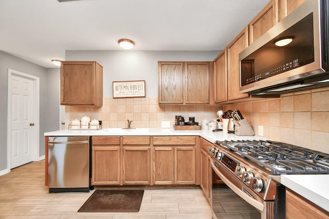 kitchen with decorative backsplash, sink, and stainless steel appliances