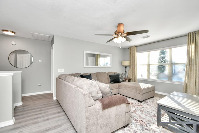 living room featuring light hardwood / wood-style floors and ceiling fan