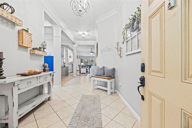 entryway featuring crown molding, light tile patterned floors, ornate columns, a ceiling fan, and baseboards