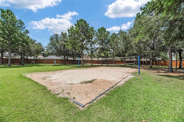 view of home's community with volleyball court and a yard