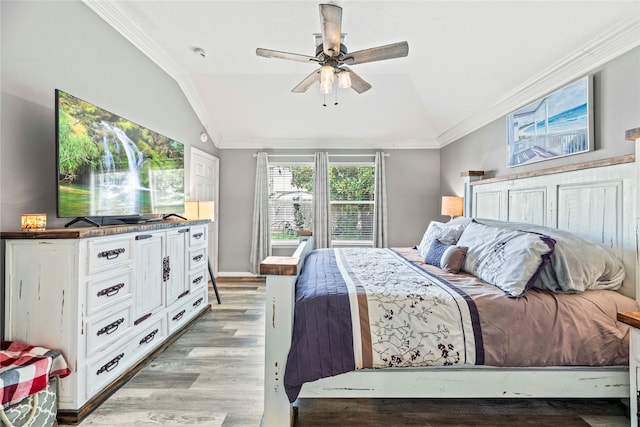 bedroom featuring ceiling fan, crown molding, vaulted ceiling, and light wood-type flooring