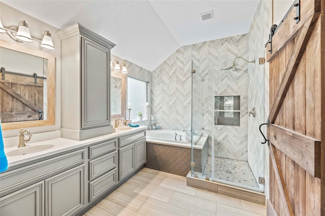 bathroom featuring vanity, separate shower and tub, and lofted ceiling