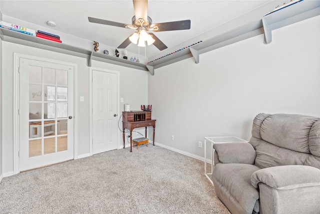 living area with ceiling fan and carpet floors