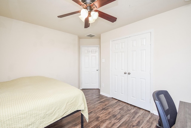 bedroom with ceiling fan, a closet, and dark wood-type flooring