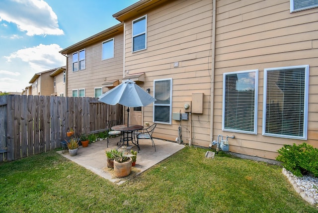 back of house featuring a patio area and a yard