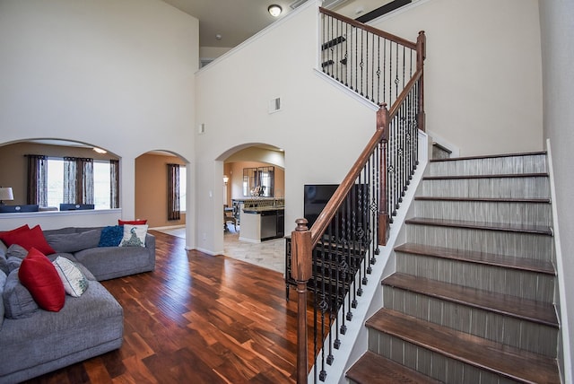 interior space with a high ceiling and hardwood / wood-style flooring