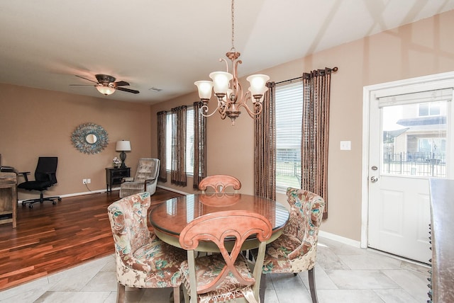 dining room featuring ceiling fan with notable chandelier and light hardwood / wood-style flooring