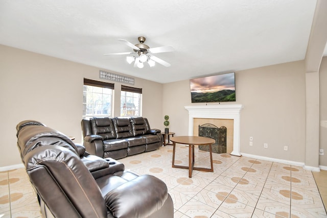 tiled living room featuring a fireplace and ceiling fan