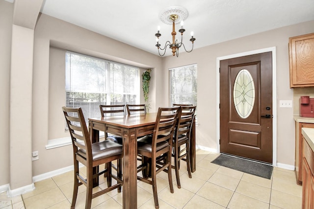 dining room featuring light tile patterned flooring and a chandelier