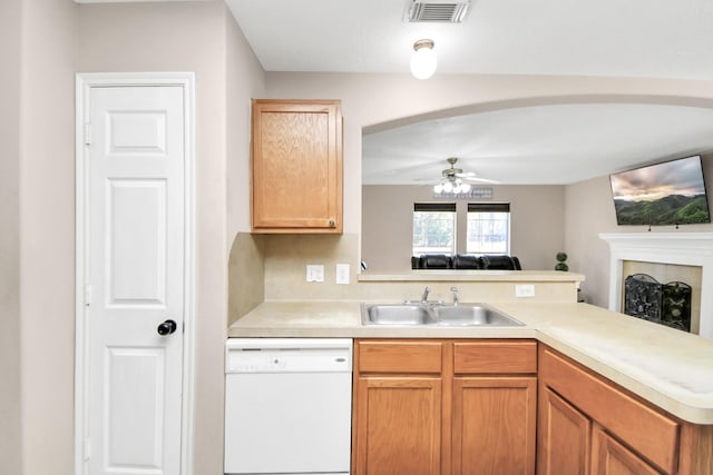 kitchen with kitchen peninsula, ceiling fan, sink, and white dishwasher