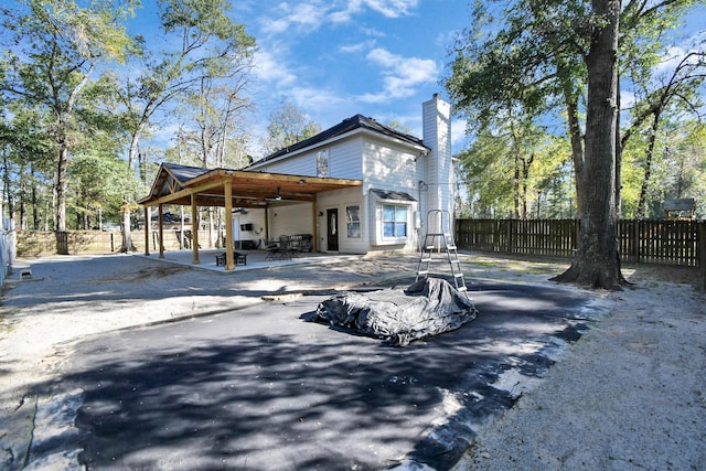 back of house featuring ceiling fan and a patio area