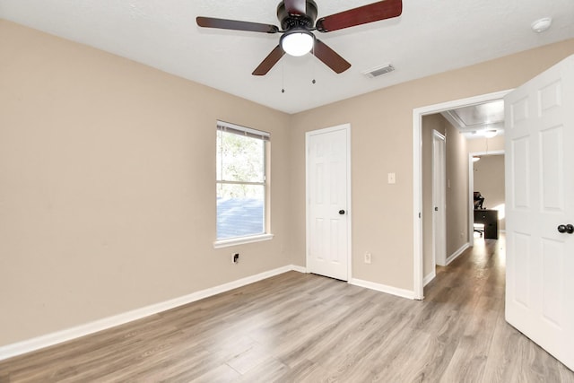 unfurnished bedroom featuring ceiling fan and light wood-type flooring