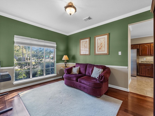 living room with crown molding and dark wood-type flooring