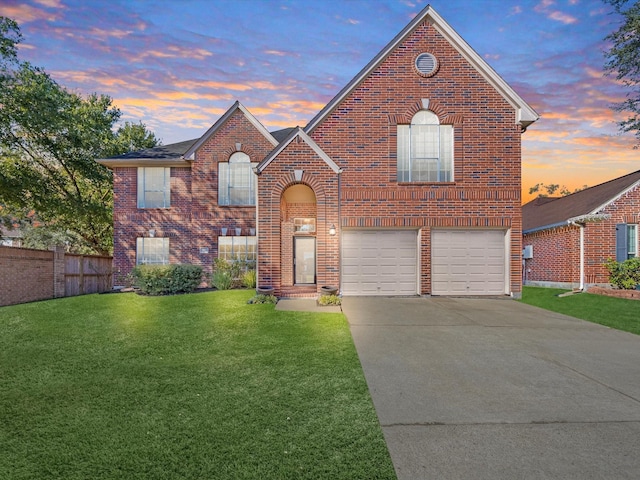 view of front of house with a yard and a garage