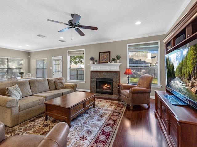 living room with ceiling fan, ornamental molding, and dark wood-type flooring