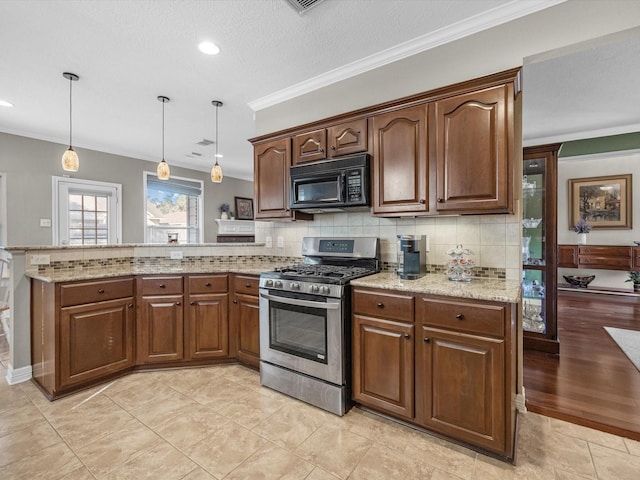 kitchen featuring tasteful backsplash, light stone counters, ornamental molding, decorative light fixtures, and stainless steel range with gas cooktop