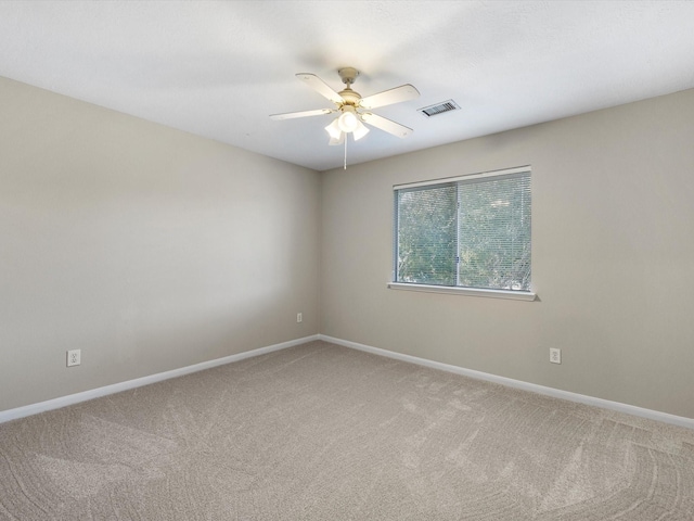 spare room featuring carpet and ceiling fan