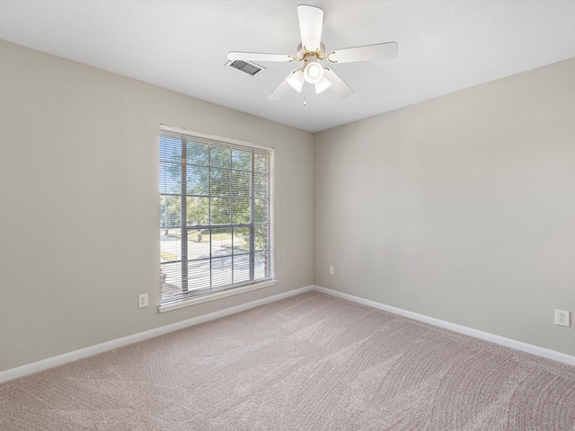 empty room with ceiling fan and carpet floors