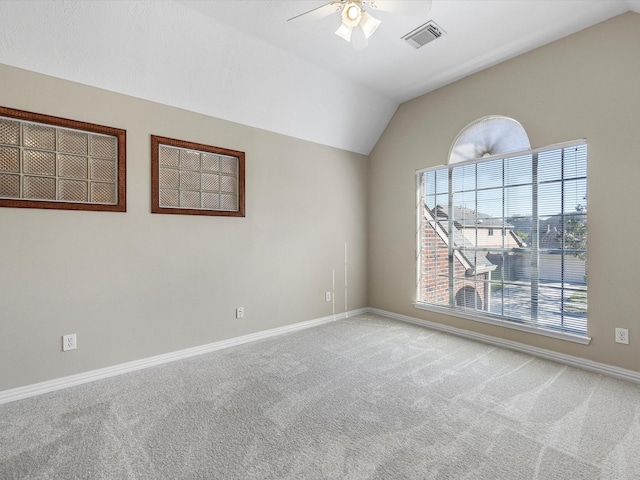 spare room with carpet flooring, ceiling fan, and vaulted ceiling