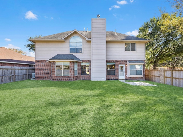 rear view of house featuring a yard