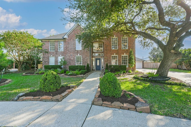 view of front of property featuring a garage, an outbuilding, and a front lawn