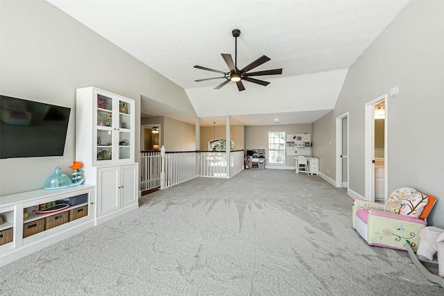 unfurnished living room featuring carpet, vaulted ceiling, and ceiling fan