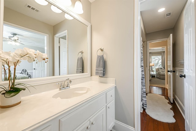 bathroom featuring ceiling fan, vanity, and wood-type flooring