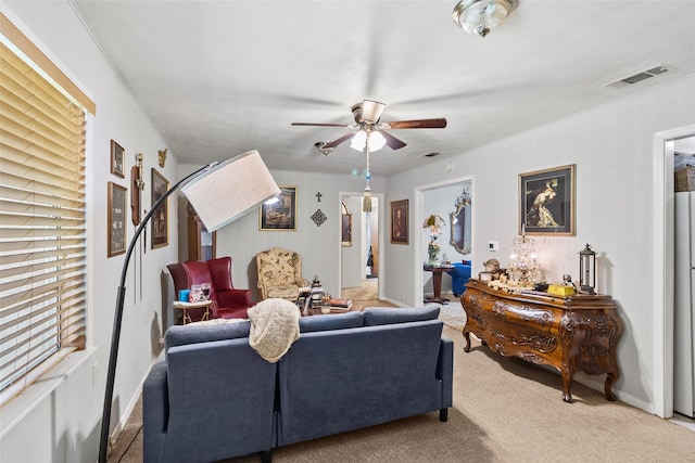 living room with ceiling fan and light colored carpet