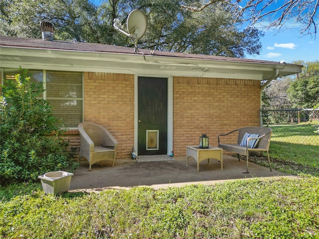 back of house featuring a patio area and a lawn