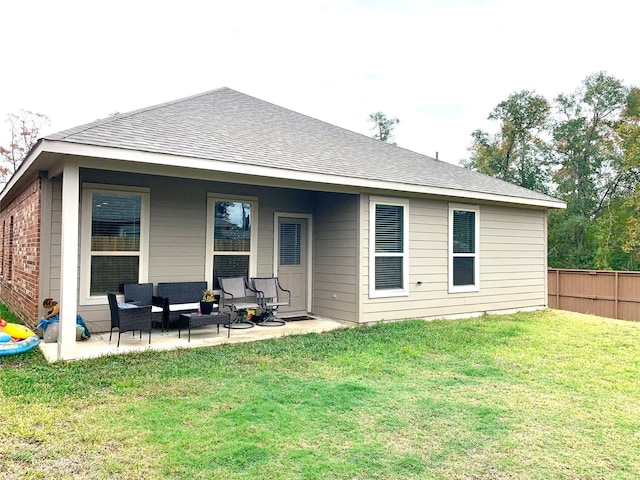 back of house featuring a patio, an outdoor hangout area, a shingled roof, fence, and a lawn