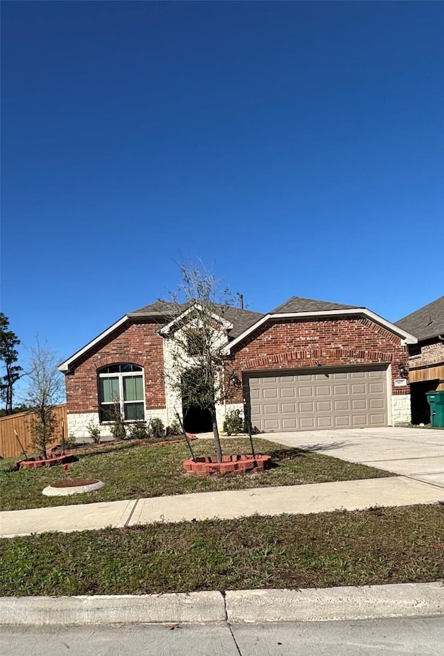 ranch-style home with brick siding, driveway, an attached garage, and fence