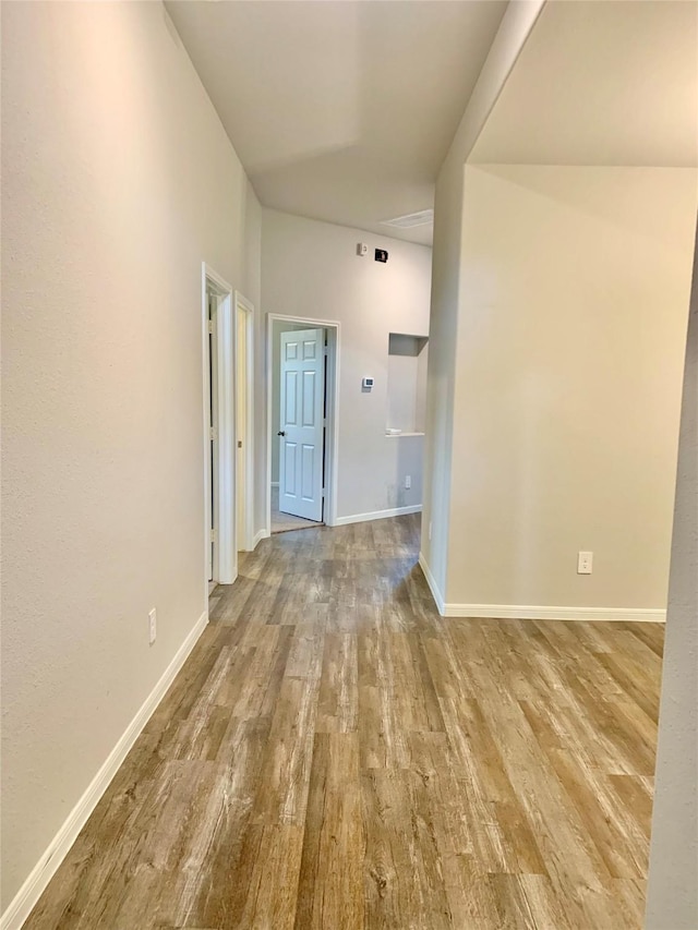 interior space with baseboards and wood finished floors