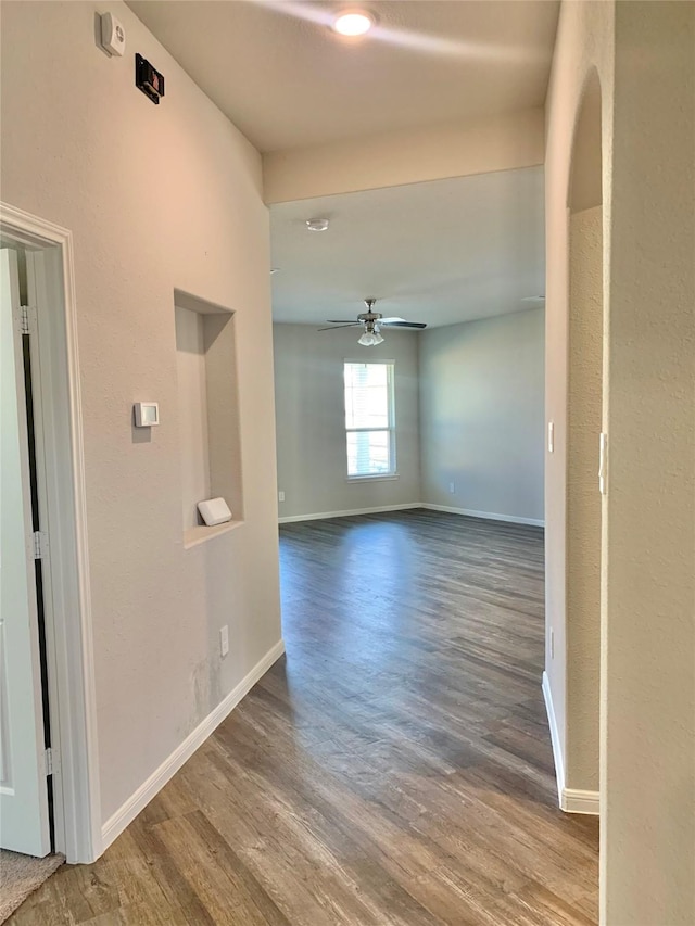 interior space with baseboards and wood finished floors