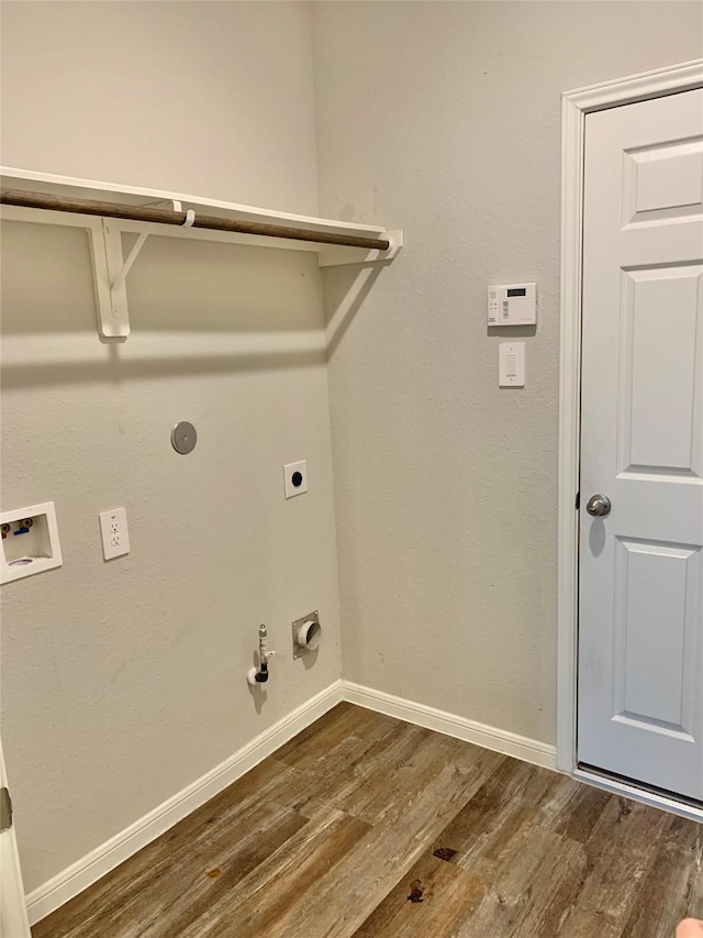 laundry room with laundry area, baseboards, gas dryer hookup, dark wood-style flooring, and electric dryer hookup