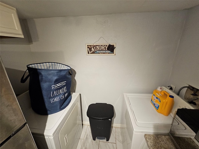 laundry area with cabinets and washer and clothes dryer