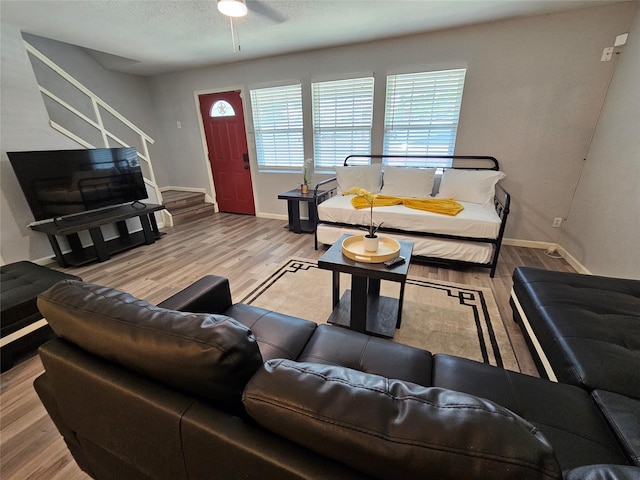 7886 Hamlet St, Houston, TX 77078 - living room with stairway, wood finished floors, baseboards, and a ceiling fan