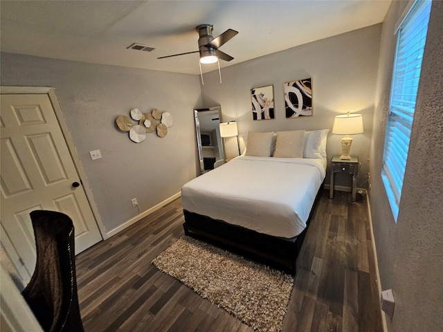 bedroom with ceiling fan and dark wood-type flooring