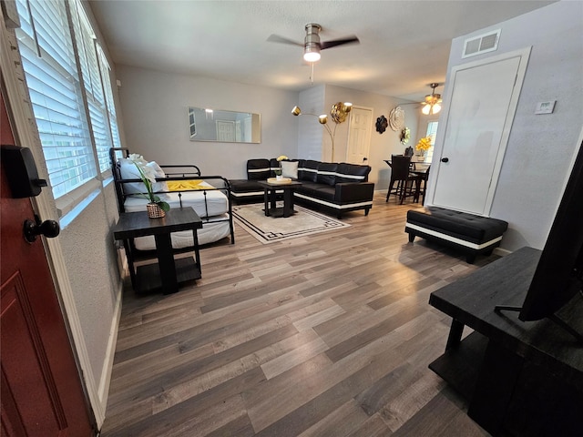 7886 Hamlet St, Houston, TX 77078 - living area with a ceiling fan, wood finished floors, and baseboards