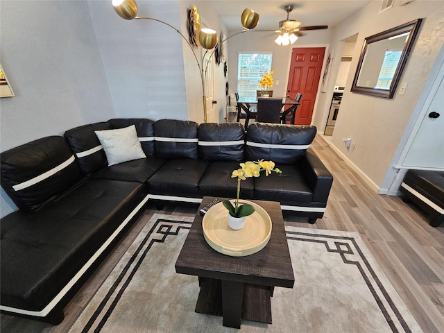 living room featuring hardwood / wood-style floors and ceiling fan