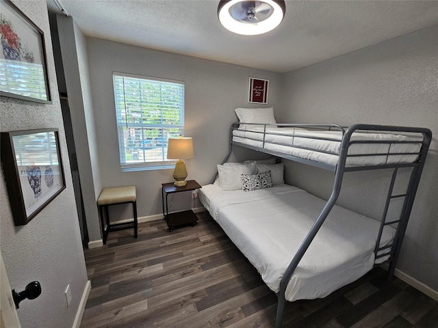 7886 Hamlet St, Houston, TX 77078 - bedroom with wood finished floors, baseboards, and a textured wall